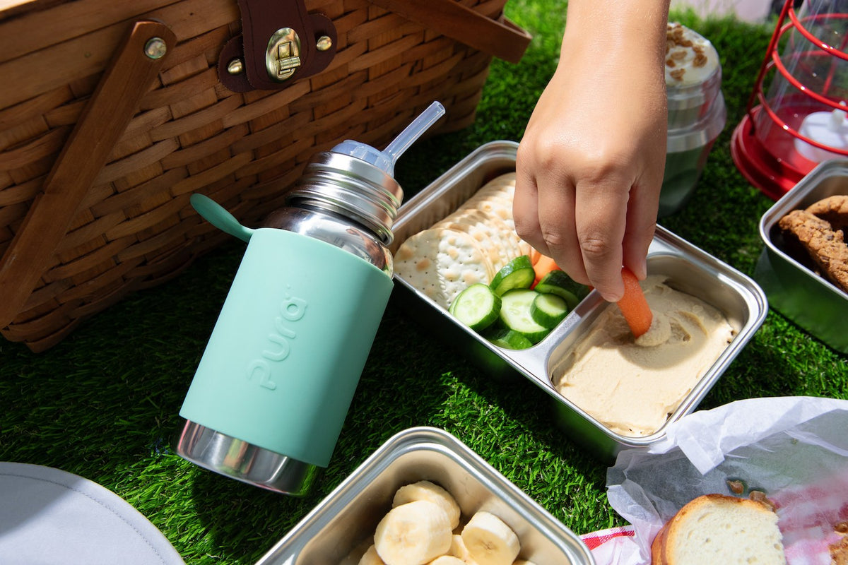 Pura fles met rietje bij een picknick